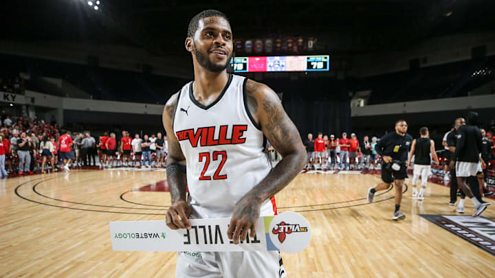TheVille's Chane Behanan smiles while carrying the team's placard after the team defeated Jackson TN at the TBT second round of the Louisville Regional at Freedom Hall July 27, 2023. TheVille's Chane Behanan smiles while carrying the team's placard after the team defeated Jackson TN at the TBT second round of the Louisville Regional at Freedom Hall July 27, 2023.