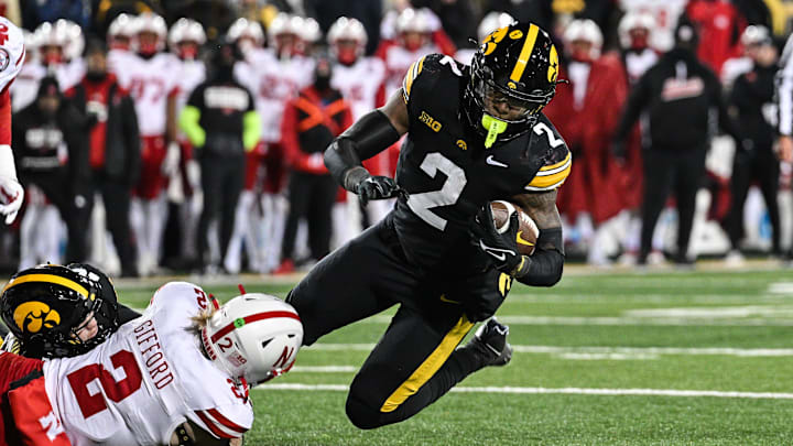 Nov 29, 2024; Iowa City, Iowa, USA; Iowa Hawkeyes running back Kaleb Johnson (2) runs the ball as Nebraska Cornhuskers defensive back Isaac Gifford (2) makes the tackle during the third quarter at Kinnick Stadium.