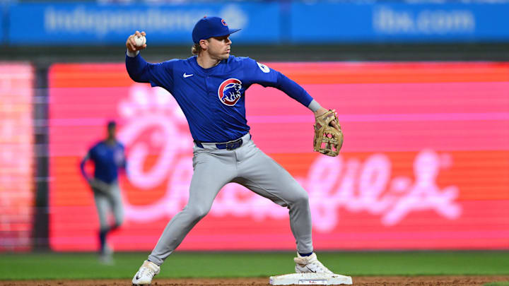 Sep 24, 2024; Philadelphia, Pennsylvania, USA; Chicago Cubs infielder Nico Hoerner (2) turns a double play against the Philadelphia Phillies.