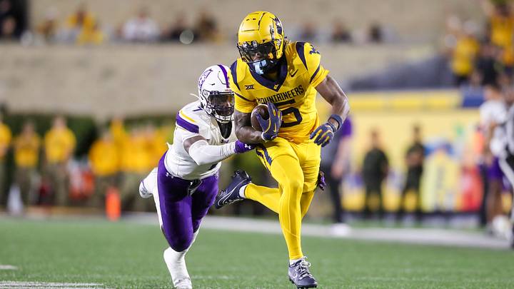 Sep 7, 2024; Morgantown, West Virginia, USA; West Virginia Mountaineers wide receiver Jaden Bray (5) catches a pass and runs for extra yards during the third quarter against the Albany Great Danes at Mountaineer Field at Milan Puskar Stadium. Mandatory Credit: Ben Queen-Imagn Images