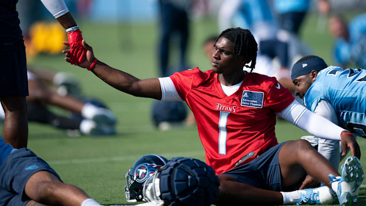 Cam Ward acknowledges a coach while stretching during the Tennessee Titans first day of training camp.