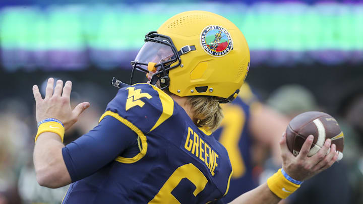 Nov 16, 2024; Morgantown, West Virginia, USA; The West Virginia National Guard logo is seen on the helmet of West Virginia Mountaineers quarterback Garrett Greene (6) during warmups prior to their game against the Baylor Bears at Mountaineer Field at Milan Puskar Stadium. Mandatory Credit: Ben Queen-Imagn Images