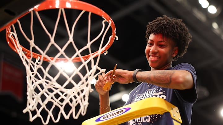 Apr 6, 2025; Tampa, FL, USA; Connecticut Huskies forward Ayanna Patterson (34) cuts down the net after the national championship of the women's 2025 NCAA tournament against the South Carolina Gamecocks at Amalie Arena. Mandatory Credit: Nathan Ray Seebeck-Imagn Images