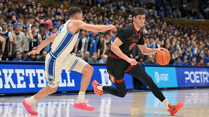 Feb 15, 2025; Durham, North Carolina, USA;  Stanford Cardinal forward Maxime Raynaud (42) brings the ball around Duke Blue Devils forward Mason Gillis (18) during the first half at Cameron Indoor Stadium. Mandatory Credit: Zachary Taft-Imagn Images