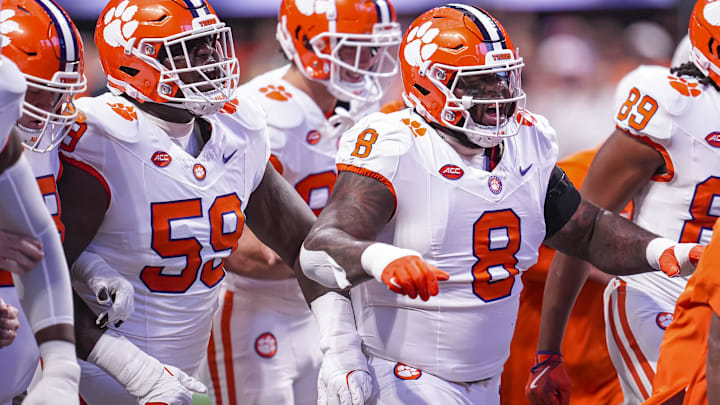 Aug 31, 2024; Atlanta, Georgia, USA; Clemson Tigers offensive lineman Dietrick Pennington (59) and defensive tackle Tre Williams (8) walk together on the field prior to the game against the Georgia Bulldogs at Mercedes-Benz Stadium. Mandatory Credit: Dale Zanine-Imagn Images