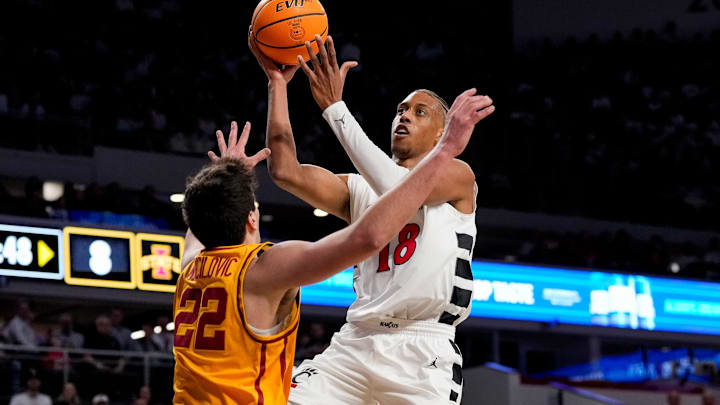 Cincinnati Bearcats forward Baba Miller (18) rises to the hoop against Iowa State Cyclones forward Milan Momcilovic (22) in the first half of the NCAA Big 12 basketball game between the Cincinnati Bearcats and the Iowa State Cyclones at Fifth Third Stadium in Cincinnati on Saturday, Jan. 17, 2026.