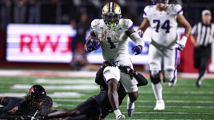 Sep 27, 2024; Piscataway, New Jersey, USA; Washington Huskies running back Jonah Coleman (1) is tackled by Rutgers Scarlet Knights defensive back Robert Longerbeam (7) during the first half at SHI Stadium. Mandatory Credit: Vincent Carchietta-Imagn Images