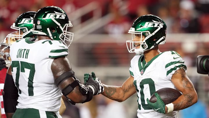 Sep 9, 2024; Santa Clara, California, USA; New York Jets wide receiver Allen Lazard (10) is congratulated by offensive tackle Tyron Smith (77) after catching a touchdown pass against the San Francisco 49ers during the fourth quarter at Levi's Stadium. Mandatory Credit: Darren Yamashita-Imagn Images