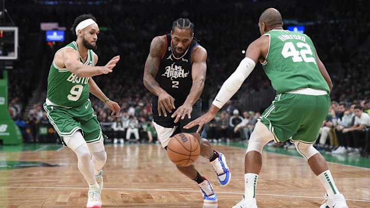 LA Clippers forward Kawhi Leonard (2) drives to the basket between Boston Celtics guard Derrick White (9) and center Al Horford (42) during the first half at TD Garden. Mandatory Credit: Bob DeChiara-Imagn Images