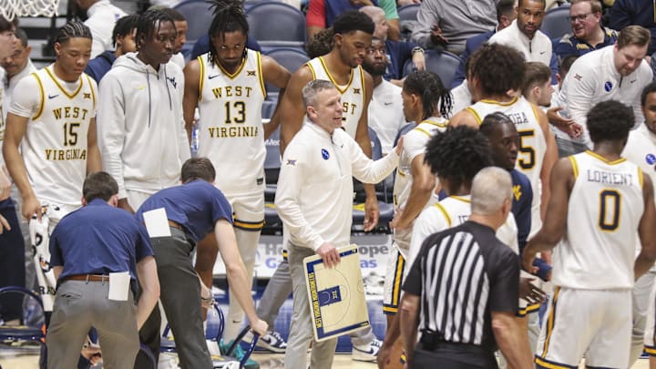Jan 17, 2026; Morgantown, West Virginia, USA; West Virginia Mountaineers head coach Ross Hodge talks to his team during a timeout during the second half against the Colorado Buffaloes at Hope Coliseum. Mandatory Credit: Ben Queen-Imagn Images