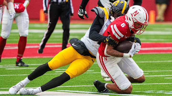 Nov 28, 2025; Lincoln, Nebraska, Nebraska Cornhuskers wide receiver Dane Key (6) is tackled by Iowa Hawkeyes defensive back Rashad Godfrey Jr. (7) during the fourth quarter at Memorial Stadium. 