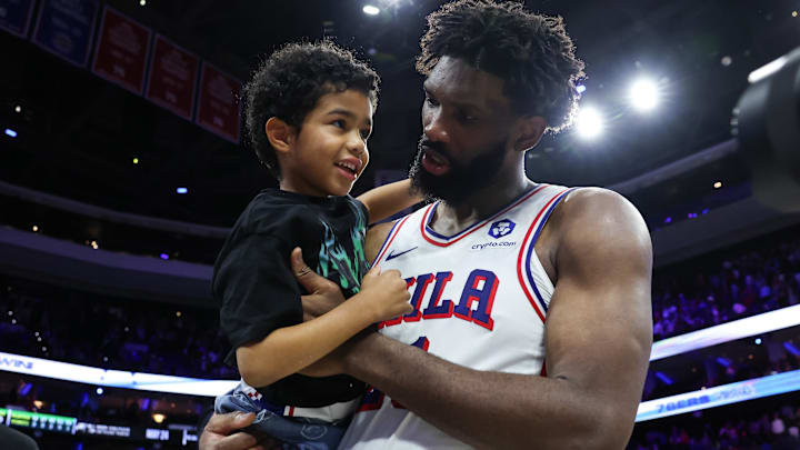 Apr 30, 2026; Philadelphia, Pennsylvania, USA; Philadelphia 76ers center Joel Embiid (21) carries his son Arthur on the court after a victory against the Boston Celtics at Xfinity Mobile Arena. Mandatory Credit: Bill Streicher-Imagn Images