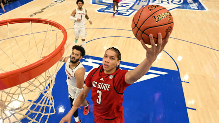 Mar 12, 2026; Charlotte, NC, USA; NC State Wolfpack guard Matt Able (3) scores as Virginia Cavaliers forward Devin Tillis (11) defends in the first half at Spectrum Center. Mandatory Credit: Bob Donnan-Imagn Images