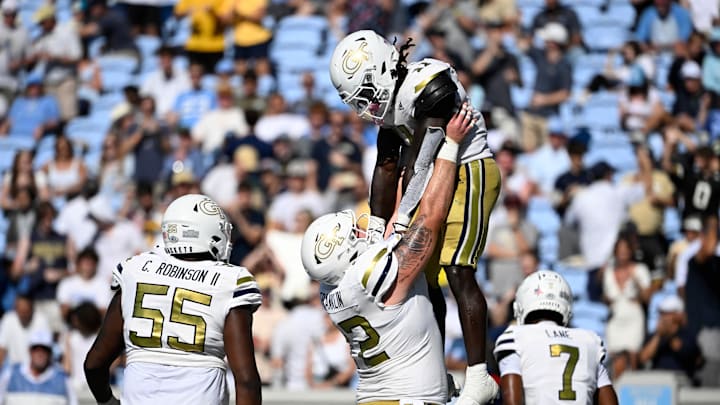 Georgia Tech running back Jamal Haynes  is hoisted after scoring a touchdown in the fourth quarter