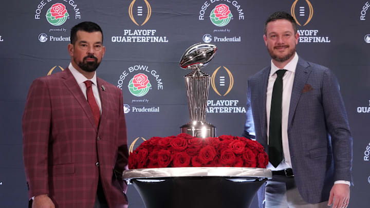 Dec 31, 2024; Los Angeles, California, USA; Ohio State Buckeyes head coach Ryan Day (left) and Oregon Ducks head coach Dan Lanning pose with the Leishman Trophy during the Rose Bowl head coaches press conference at Sheraton Grand LA. Mandatory Credit: Kirby Lee-Imagn Images