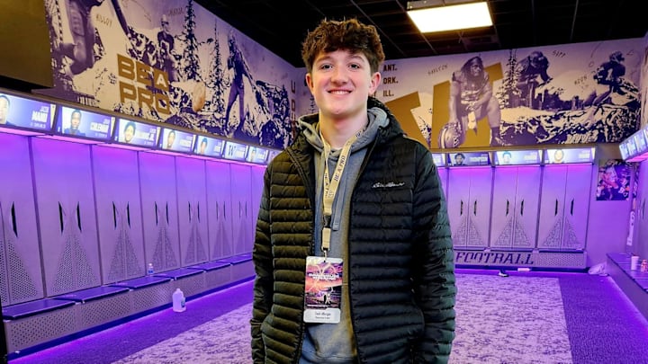 Zach Albright spends a moment in the UW football locker room.
