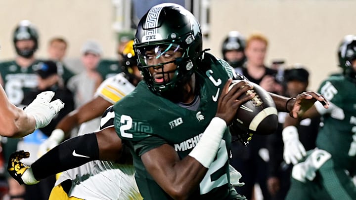 Oct 19, 2024; East Lansing, Michigan, USA;  Michigan State Spartans quarterback Aidan Chiles (2) scrambles against the Iowa Hawkeyes during the first quarter at Spartan Stadium. Mandatory Credit: Dale Young-Imagn Images