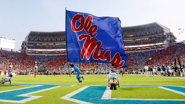 Sep 13, 2025; Oxford, Mississippi, USA; Mississippi Rebels cheerleaders run an Ole Miss flag across the field after a touchdown during the second quarter against the Arkansas Razorback at Vaught-Hemingway Stadium. Mandatory Credit: Petre Thomas-Imagn Images Sep 13, 2025; Oxford, Mississippi, USA; Mississippi Rebels cheerleaders run an Ole Miss flag across the field after a touchdown during the second quarter against the Arkansas Razorback at Vaught-Hemingway Stadium. Mandatory Credit: Petre Thomas-Imagn Images