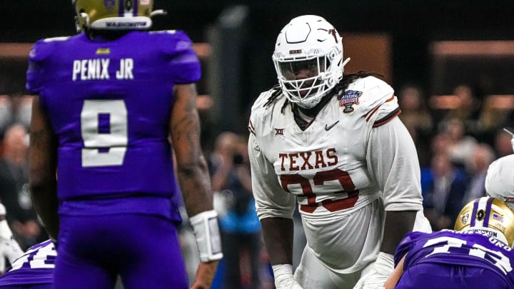 Texas Longhorns defensive lineman T'Vondre Sweat (93) watches Washington quarterback Michael Penix