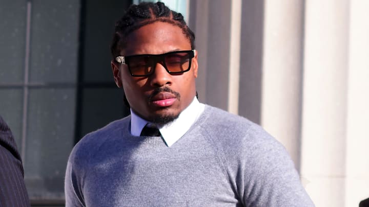 New England Patriots wide receiver Stefon Diggs leaves Dedham District Court in Dedham, Massachusetts, on Friday, Feb. 13, 2026, after his arraignment on charges of felony strangulation or suffocation and misdemeanor assault over an alleged pay dispute with a private chef. He pled not guilty and was released on personal recognizance.