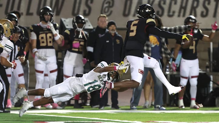 Oaks Christian's Davon Benjamin leaps free from St. Bonaventure's Darrien Johnson return an interception for a touchdown in the third quarter of Oaks Christian's win over visiting St. Bonaventure Friday at Redell Field. The Lions won, 35-0.