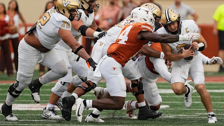 Nov 1, 2025; Austin, Texas, USA; Vanderbilt Commodores quarterback Diego Pavia (2) is tackled by Texas Longhorns defensive lineman Brad Spence (14).