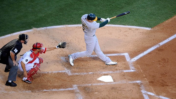 Apr 6, 2009; Los Angeles, CA, USA; Oakland Athletics left fielder Matt Holliday (5) bats during the 2009 Opening Day game as Los Angeles Angels catcher Jeff Mathis (center) and home plate umpire Charlie Reliford (left) look on at Angel Stadium. Mandatory Credit: Kirby Lee/Image of Sport-Imagn Images Apr 6, 2009; Los Angeles, CA, USA; Oakland Athletics left fielder Matt Holliday (5) bats during the 2009 Opening Day game as Los Angeles Angels catcher Jeff Mathis (center) and home plate umpire Charlie Reliford (left) look on at Angel Stadium. Mandatory Credit: Kirby Lee/Image of Sport-Imagn Images
