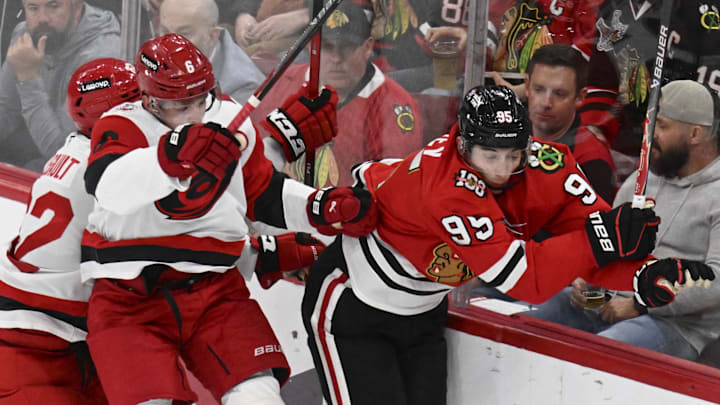 Apr 9, 2026; Chicago, Illinois, USA; Carolina Hurricanes defenseman Mike Reilly (6) checks Chicago Blackhawks right wing Ilya Mikheyev (95) during the second period at the United Center. Mandatory Credit: Matt Marton-Imagn Images Apr 9, 2026; Chicago, Illinois, USA; Carolina Hurricanes defenseman Mike Reilly (6) checks Chicago Blackhawks right wing Ilya Mikheyev (95) during the second period at the United Center. Mandatory Credit: Matt Marton-Imagn Images