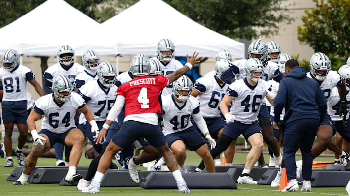 Jun 10, 2025; Arlington, TX, USA;  Dallas Cowboys quarterback Dak Prescott (4) leads teammates through a drill at the Ford Center at the Star Training Facility in Frisco, Texas. Mandatory Credit: Chris Jones-Imagn Images
