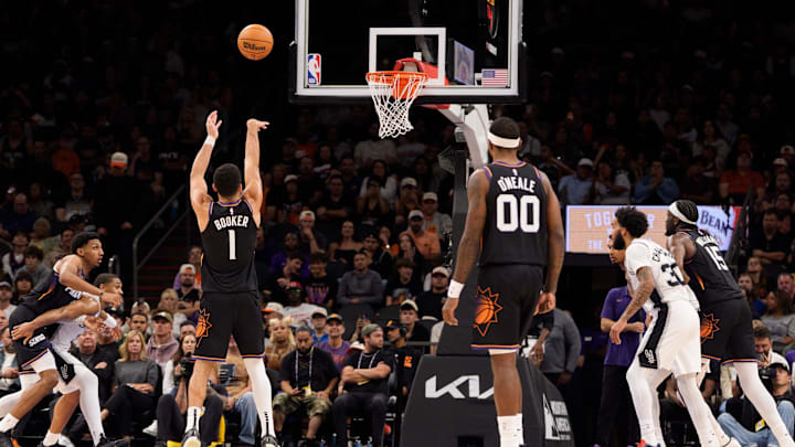 Nov 2, 2025; Phoenix, Arizona, USA; Phoenix Suns guard Devin Booker (1) shoots a free throw during the second half against the San Antonio Spurs at Mortgage Matchup Center. Mandatory Credit: Allan Henry-Imagn Images