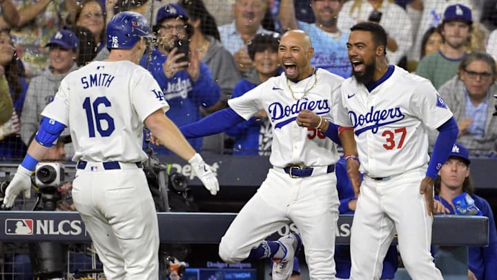 Oct 20, 2024; Los Angeles, California, USA; Los Angeles Dodgers catcher Will Smith (16) celebrates with outfielder Mookie Betts (50) and outfielder Teoscar Hernandez (37) after hitting a two run home run in the third inning against the New York Mets during game six of the NLCS for the 2024 MLB playoffs at Dodger Stadium. Mandatory Credit: Jayne Kamin-Oncea-Imagn Images