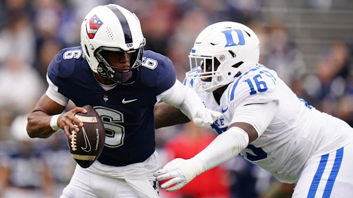 Sep 23, 2023; East Hartford, Connecticut, USA; UConn Huskies quarterback Ta'Quan Roberson (6) is sacked by Duke Blue Devils defensive tackle Aeneas Peebles (16) in the second quarter at Rentschler Field at Pratt & Whitney Stadium. Mandatory Credit: David Butler II-Imagn Images