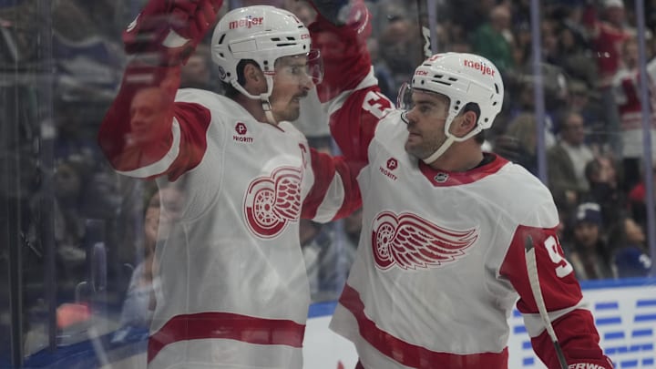 Nov 8, 2024; Toronto, Ontario, CAN; Detroit Red Wings forward Alex DeBrincat (93) congratulates forward Dylan Larkin (71) on his goal against the Toronto Maple Leafs during the second period at Scotiabank Arena. Mandatory Credit: John E. Sokolowski-Imagn Images