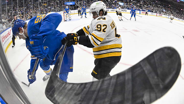 Dec 9, 2025; St. Louis, Missouri, USA; St. Louis Blues defenseman Colton Parayko (55) and Boston Bruins center Marat Khusnutdinov (92) battle for the puck during the third period at Enterprise Center. Mandatory Credit: Jeff Curry-Imagn Images Dec 9, 2025; St. Louis, Missouri, USA; St. Louis Blues defenseman Colton Parayko (55) and Boston Bruins center Marat Khusnutdinov (92) battle for the puck during the third period at Enterprise Center. Mandatory Credit: Jeff Curry-Imagn Images