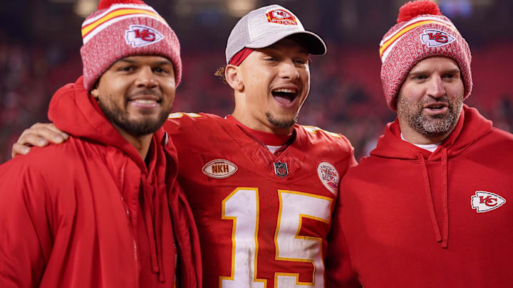 Dec 31, 2023; Kansas City, Missouri, USA; Kansas City Chiefs quarterback Chris Oladokun (13), quarterback Patrick Mahomes (15), and quarterbacks coach David Girardi (left to right) pose for a photo after the game against the Cincinnati Bengals at GEHA Field at Arrowhead Stadium.
