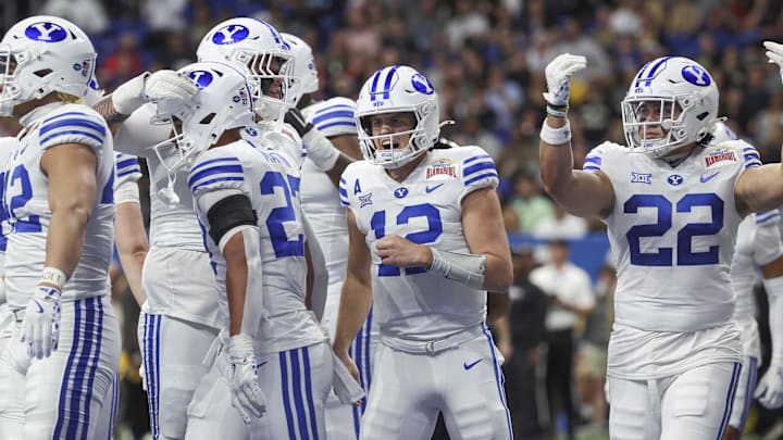 Dec 28, 2024; San Antonio, TX, USA; Brigham Young Cougars quarterback Jake Retzlaff (12) celebrates after a touchdown during the first quarter against the Colorado Buffaloes at Alamodome. Mandatory Credit: Troy Taormina-Imagn Images