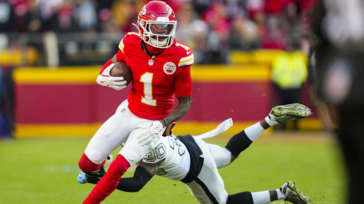 Nov 29, 2024; Kansas City, Missouri, USA; Kansas City Chiefs wide receiver Xavier Worthy (1) runs with the ball against Las Vegas Raiders cornerback Darnay Holmes (30) during the first half at GEHA Field at Arrowhead Stadium. Mandatory Credit: Jay Biggerstaff-Imagn Images