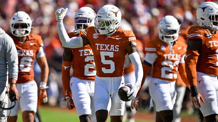 Oct 11, 2025; Dallas, Texas, USA; Texas Longhorns defensive back Malik Muhammad (5) celebrates after an interception during the game between the Texas Longhorns and the Oklahoma Sooners at the Cotton Bowl. Mandatory Credit: Jerome Miron-Imagn Images
