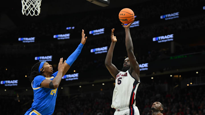 Dec 13, 2025; Seattle, Washington, USA; Gonzaga Bulldogs forward Emmanuel Innocenti (5) shoots the ball over UCLA Bruins center Steven Jamerson II (24) during the first half at Climate Pledge Arena. Dec 13, 2025; Seattle, Washington, USA; Gonzaga Bulldogs forward Emmanuel Innocenti (5) shoots the ball over UCLA Bruins center Steven Jamerson II (24) during the first half at Climate Pledge Arena.