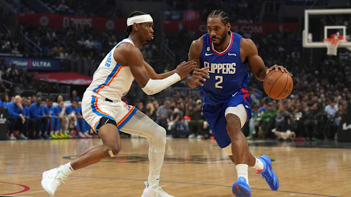 LA Clippers forward Kawhi Leonard (right) dribbles the ball against Oklahoma City Thunder guard Shai Gilgeous-Alexander in the first half at Crypto.com Arena. Mandatory Credit: Kirby Lee-Imagn Images