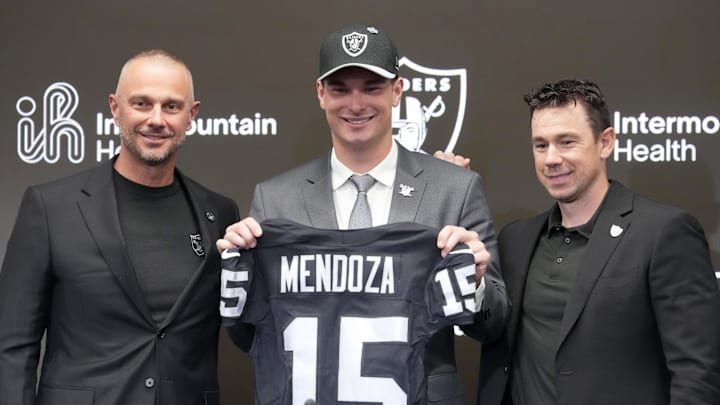 Las Vegas Raiders quarterback Fernando Mendoza (center) poses with general manager John Spytek (left) and head coach Klint Kubiak at introductory press conference.