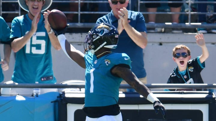 Jacksonville Jaguars running back Travis Etienne Jr. (1) celebrates in the end zone with fans after
