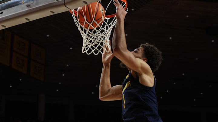 Feb 27, 2023; Ames, Iowa, USA; West Virginia Mountaineers forward Emmitt Matthews Jr. (1) scores against the Iowa State Cyclones during the first half at James H. Hilton Coliseum. Mandatory Credit: Reese Strickland-Imagn Images