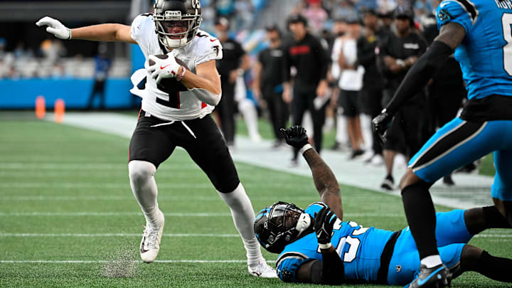 Oct 13, 2024; Charlotte, North Carolina, USA; Atlanta Falcons wide receiver Drake London (5) with the ball as Carolina Panthers linebacker Claudin Cherelus (53) and cornerback Jaycee Horn (8) defend in the second quarter at Bank of America Stadium.