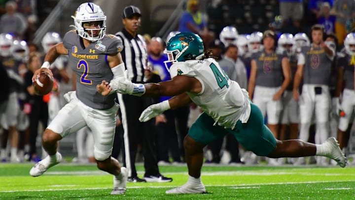Dec 23, 2023; Honolulu, HI, USA; San Jose State Spartans quarterback Chevan Cordeiro (2) scrambles away from Coastal Carolina Chanticleers defensive lineman Will Whitson (44) during the third quarter of the Easypost Hawaii Bowl at Clarence T.C. Ching Athletics Complex. Mandatory Credit: Steven Erler-Imagn Images