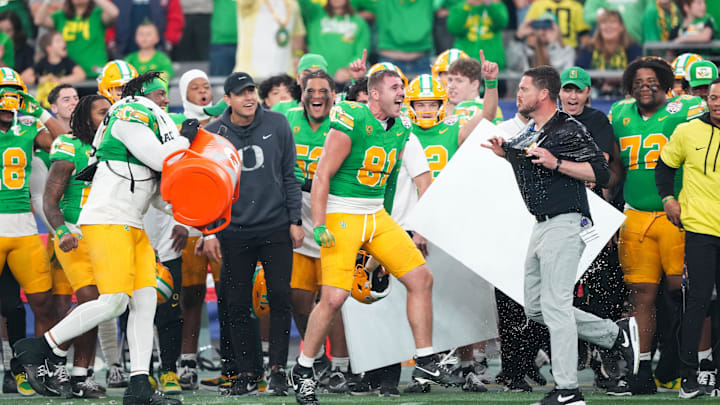 Jan 1, 2024; Glendale, AZ, USA; Oregon Ducks head coach Dan Lanning reacts after being doused in Gatorade at the end of the 2024 Fiesta Bowl against the Liberty Flames at State Farm Stadium. The Ducks won 45-6. Mandatory Credit: Joe Camporeale-USA TODAY Sports