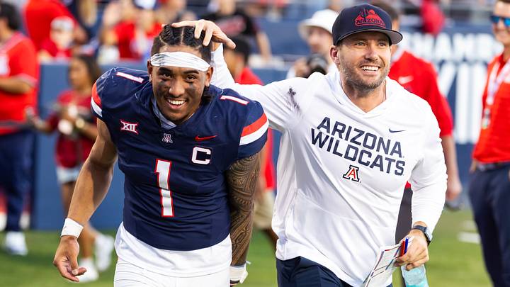 Nov 8, 2025; Tucson, Arizona, USA; Arizona Wildcats quarterback Noah Fifita (1) celebrates with offensive coordinator Seth Doege after defeating the Kansas Jayhawks at Arizona Stadium. Mandatory Credit: Mark J. Rebilas-Imagn Images Nov 8, 2025; Tucson, Arizona, USA; Arizona Wildcats quarterback Noah Fifita (1) celebrates with offensive coordinator Seth Doege after defeating the Kansas Jayhawks at Arizona Stadium. Mandatory Credit: Mark J. Rebilas-Imagn Images