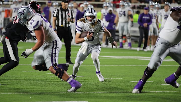 Oct 14, 2023; Lubbock, Texas, USA;  Kansas State Wildcats quarterback Avery Johnson (5) rushes up the middle in attempt to get the first down against the Texas Tech Raiders.