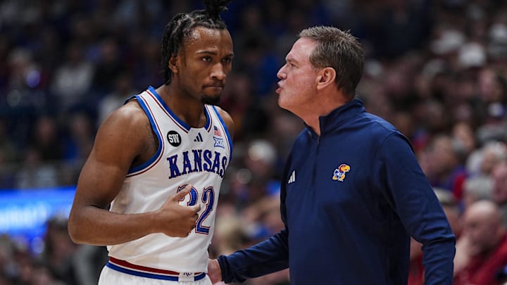 Jan 13, 2026; Lawrence, Kansas, USA; Kansas Jayhawks guard Darryn Peterson (22) talks to head coach Bill Self during the first half against the Iowa State Cyclones at Allen Fieldhouse. Mandatory Credit: Jay Biggerstaff-Imagn Images