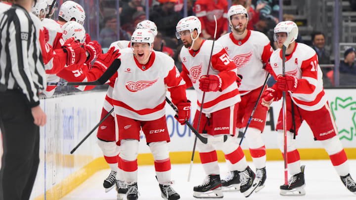 Feb 4, 2025; Seattle, Washington, USA; Detroit Red Wings right wing Jonatan Berggren (48) celebrates with the bench after scoring a goal against the Seattle Kraken during the second period at Climate Pledge Arena. Mandatory Credit: Steven Bisig-Imagn Images